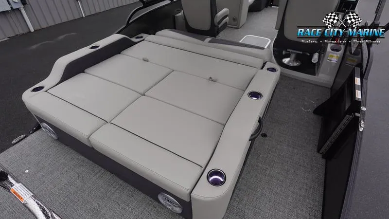 Slide: The Image of 2025 Barletta C22UC pontoon boat interior with convertible seating and cup holders. - 15