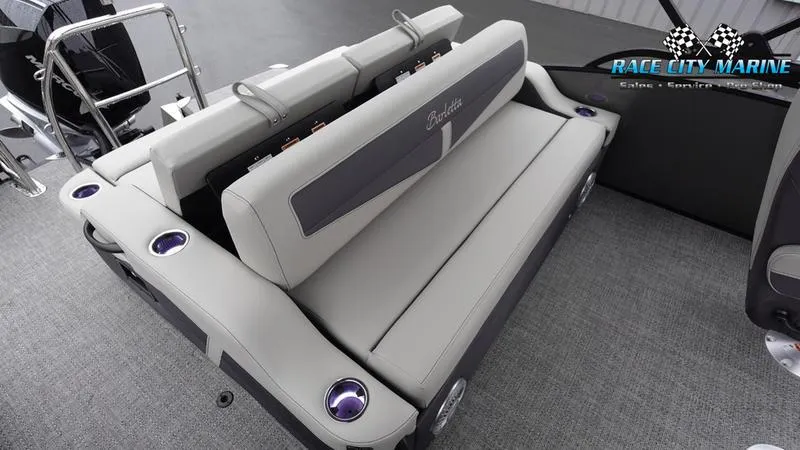 Slide: The Image of 2025 Barletta C22UC boat interior with plush seating and cup holders. - 17