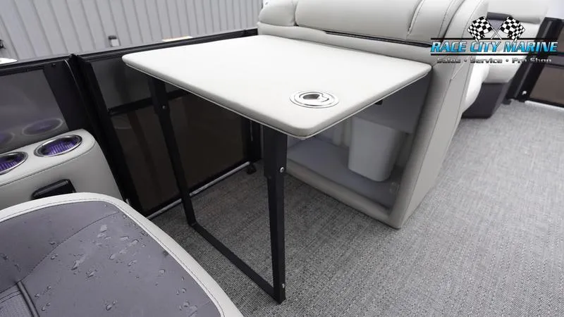 Slide: The Image of 2025 Barletta C22UC boat interior with foldable table and seating. - 24