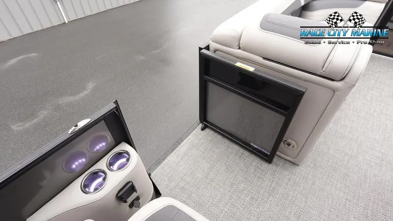 Slide: The Image of 2025 Barletta C22UC boat interior with cup holders and storage compartment. - 26