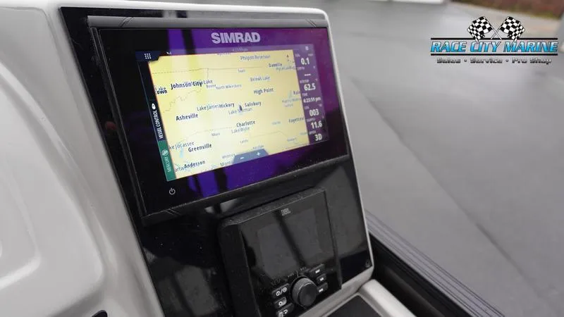 Slide: The Image of Simrad navigation system on 2025 Barletta C22UC boat dashboard, Race City Marine logo visible. - 32