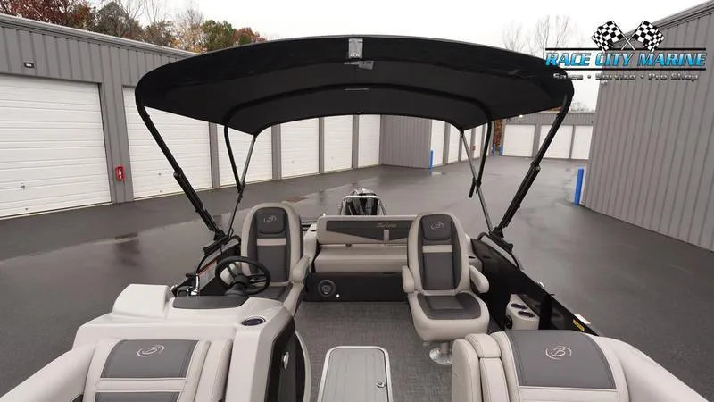 Slide: The Image of 2025 Barletta C22UC pontoon boat with canopy, parked at Race City Marine. - 47