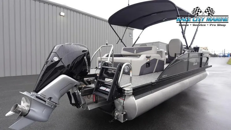 Slide: The Image of 2025 Barletta C22UC pontoon boat with outboard motor and canopy, docked at marina. - 8