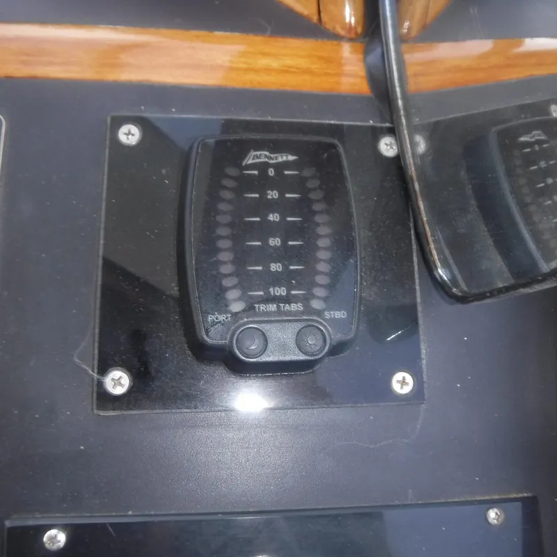 Slide: The Image of Trim tab control panel on 1998 Legacy 40' Flybridge boat. - 10