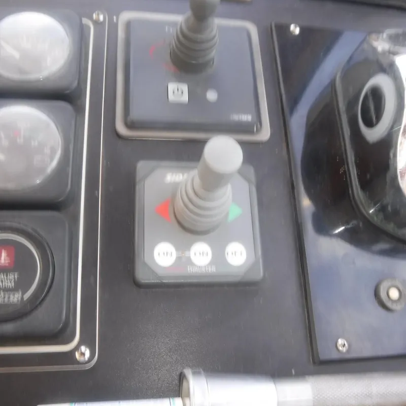 Slide: The Image of Control panel of 1998 Legacy 40' Flybridge with joysticks and gauges. - 11