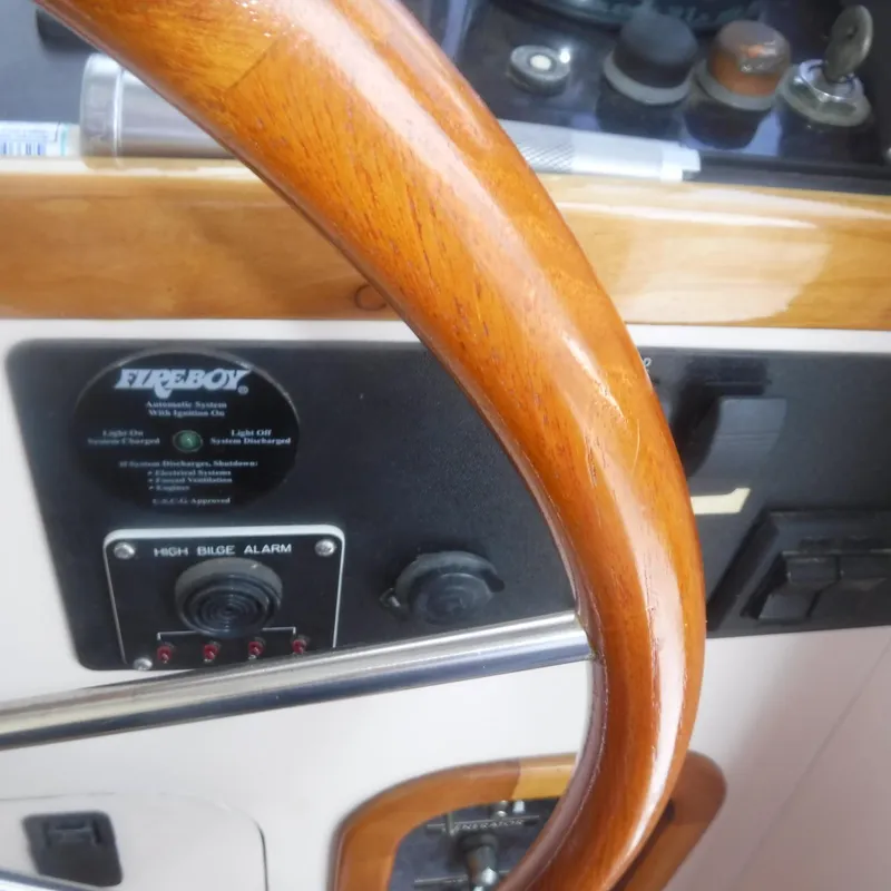 Slide: The Image of Wooden steering wheel on 1998 Legacy 40' Flybridge yacht dashboard. - 15