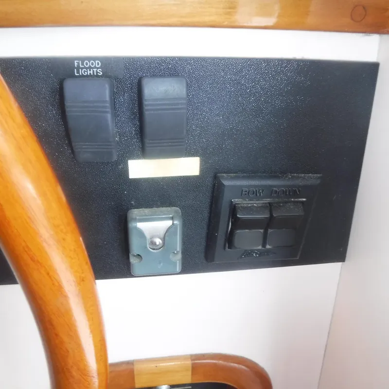 Slide: The Image of Control panel of 1998 Legacy 40' Flybridge with floodlight switches and bow controls. - 16