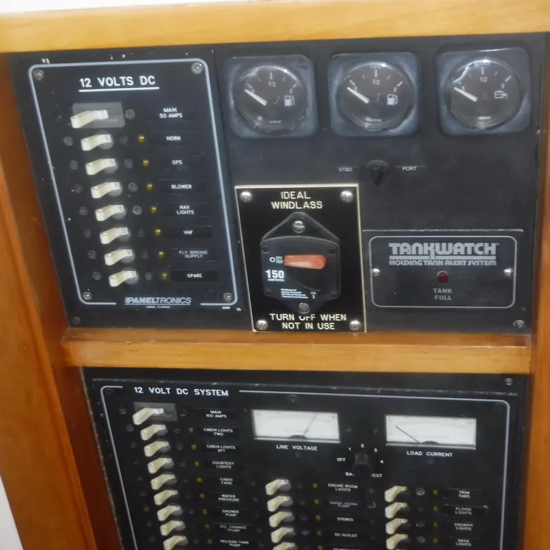 Slide: The Image of Electrical panel of 1998 Legacy 40' Flybridge boat, featuring 12V DC system controls. - 23