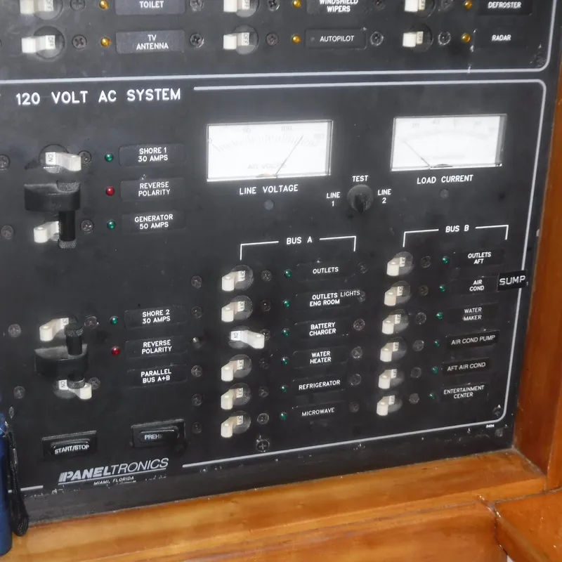 Slide: The Image of Electrical panel of 1998 Legacy 40' Flybridge boat, showing 120V AC system controls. - 26