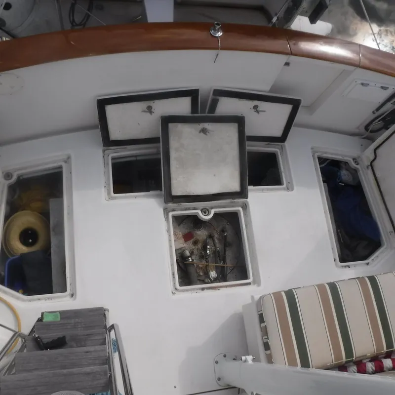 Slide: The Image of 1998 Legacy 40' Flybridge boat deck with open storage compartments. - 38