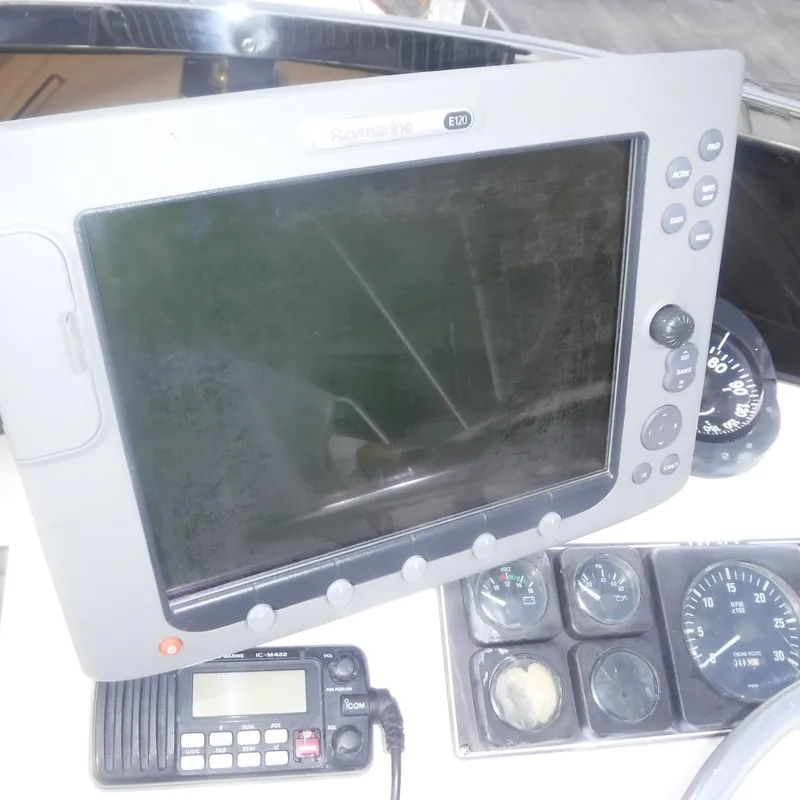 Slide: The Image of Boat navigation equipment on 1998 Legacy 40' Flybridge, featuring Raymarine E120 display. - 41