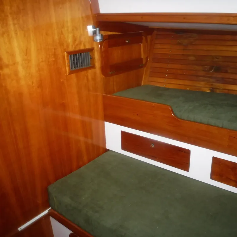 Slide: The Image of Legacy 40' Flybridge 1998 interior with wooden bunk beds and green cushions. - 48