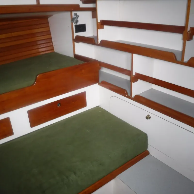 Slide: The Image of Interior of 1998 Legacy 40' Flybridge with green cushions and wooden shelving. - 49