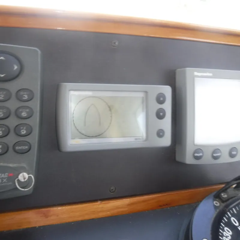 Slide: The Image of Legacy 40' Flybridge 1998 dashboard with navigation instruments and controls. - 8