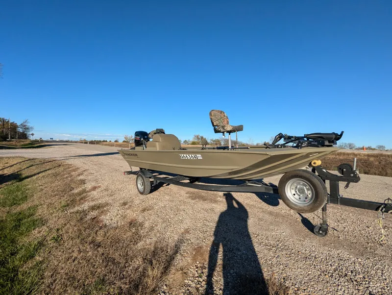 Slide: The Image of 2023 Tracker Grizzly 1648 SC boat on trailer under clear blue sky. - 10