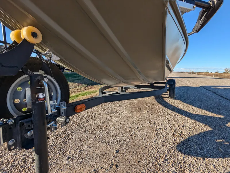 Slide: The Image of 2023 Tracker Grizzly 1648 SC boat on trailer, side view, sunny day. - 12