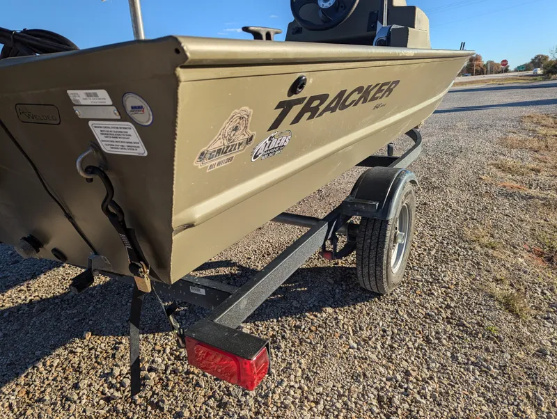 Slide: The Image of 2023 Tracker Grizzly 1648 SC boat on a trailer, parked on gravel. - 7