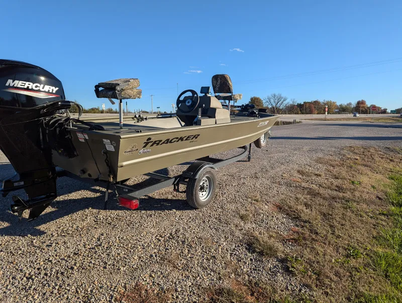 Slide: The Image of 2023 Tracker Grizzly 1648 SC boat with Mercury engine on gravel road. - 8