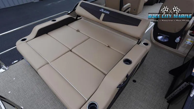 Slide: The Image of 2025 Barletta C22UC boat interior with tan seating and cup holders. - 12