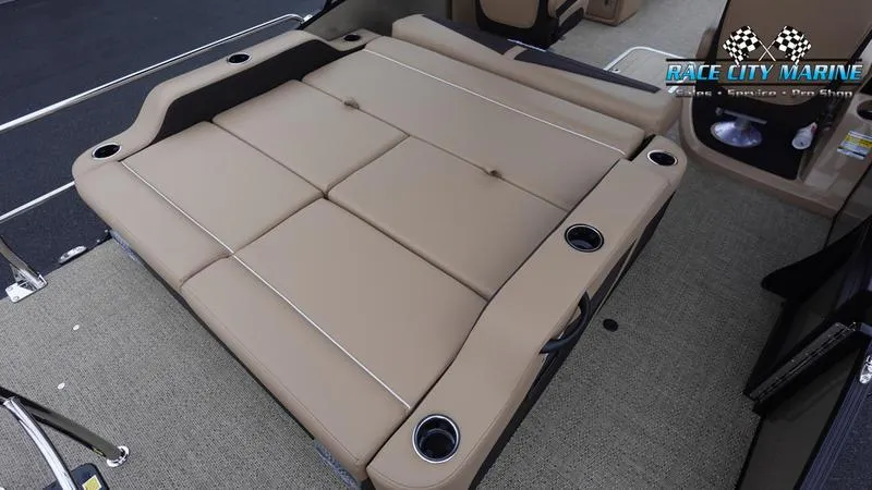 Slide: The Image of 2025 Barletta C22UC boat interior with tan convertible seating and cup holders. - 13