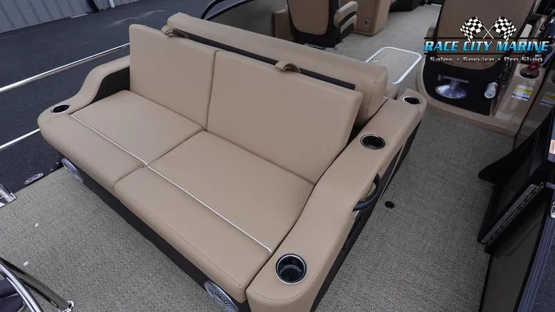 Slide: The Image of 2025 Barletta C22UC boat interior with tan seating and cup holders. - 14