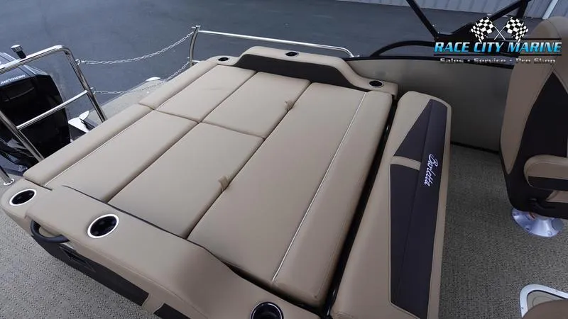 Slide: The Image of 2025 Barletta C22UC boat interior with beige seating and cup holders. - 18