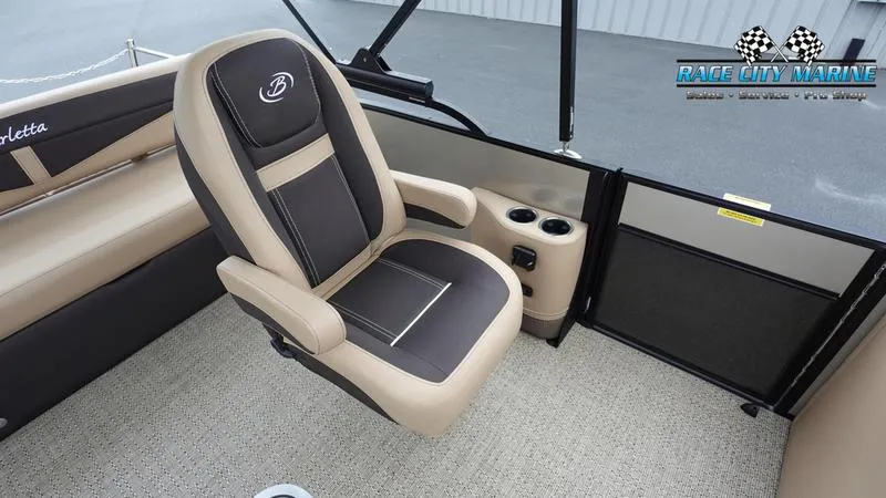 Slide: The Image of 2025 Barletta C22UC boat interior with beige and black seating, cup holders, and Race City Marine logo. - 19