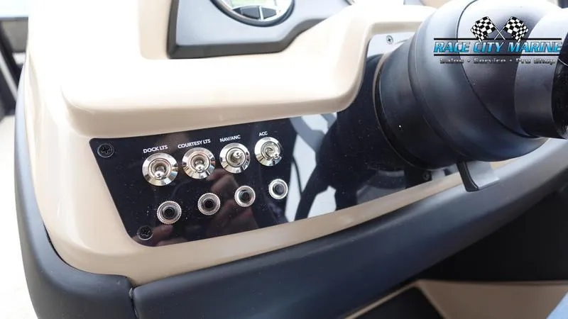 Slide: The Image of Control panel of 2025 Barletta C22UC boat with labeled switches and Race City Marine logo. - 37