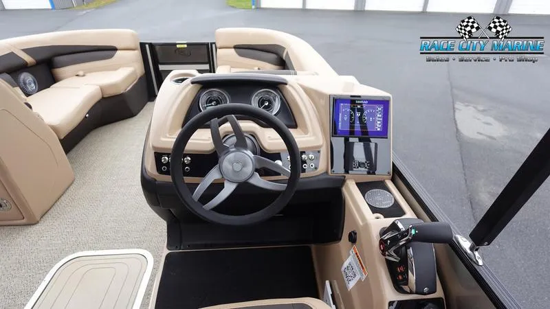 Slide: The Image of Interior of 2025 Barletta C22UC boat with steering wheel and dashboard controls. - 38