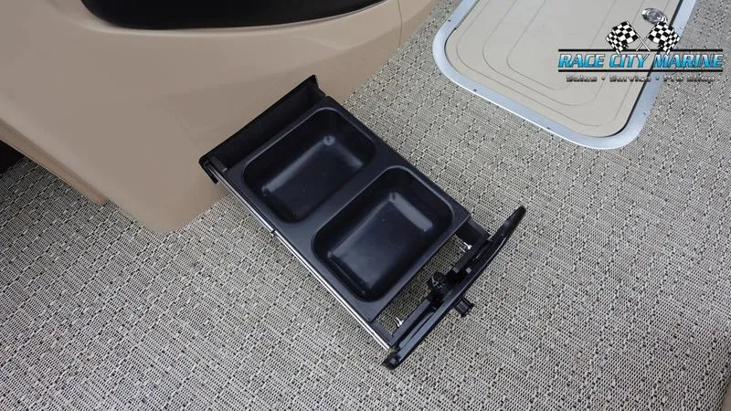 Slide: The Image of Barletta C22UC 2025 boat with pull-out storage tray on carpeted floor. - 39