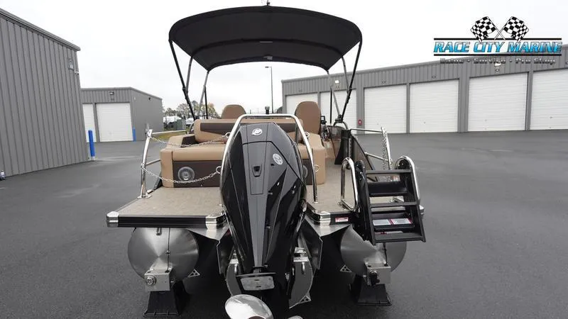 Slide: The Image of 2025 Barletta C22UC pontoon boat with outboard motor, parked at Race City Marine. - 4