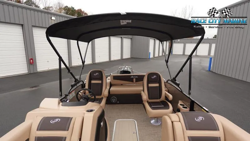Slide: The Image of 2025 Barletta C22UC pontoon boat interior with seating and canopy. - 48