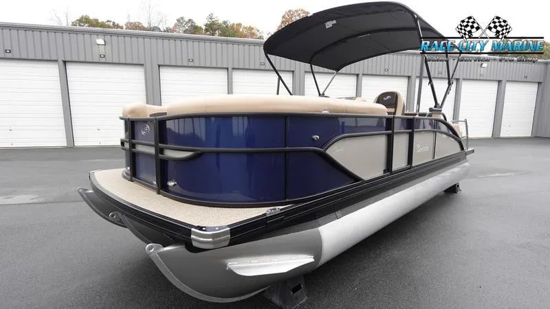 Slide: The Image of 2025 Barletta C22UC pontoon boat with canopy in a marina setting. - 6