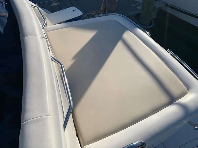 Slide: The Image of 2014 Sea Ray 410 Sundancer boat seating area with white upholstery. - 10
