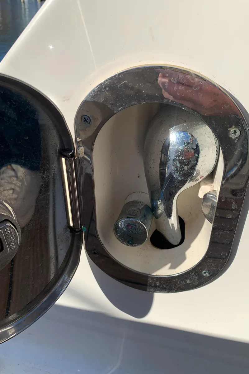 Slide: The Image of 2014 Sea Ray 410 Sundancer boat fuel cap in open compartment. - 11