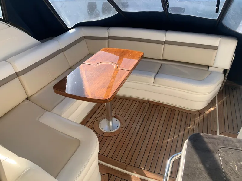 Slide: The Image of Luxurious seating area on 2014 Sea Ray 410 Sundancer yacht with wooden table. - 14