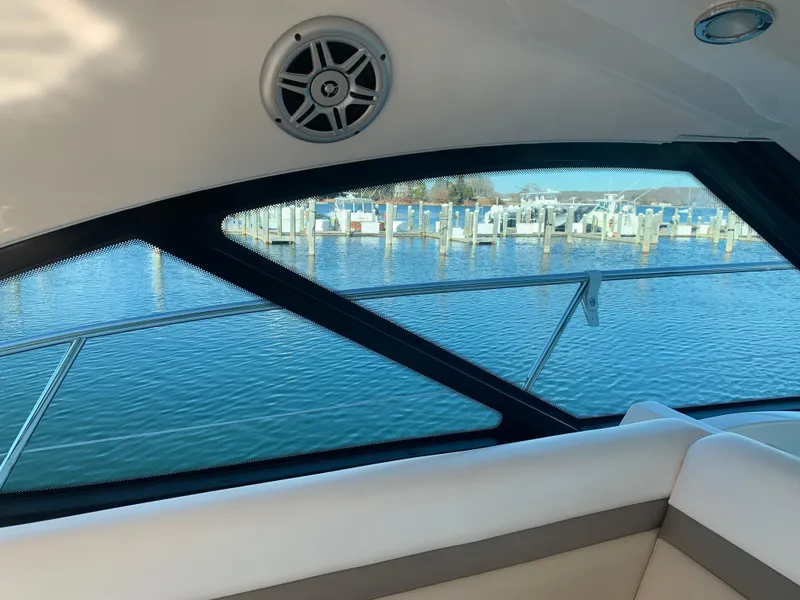 Slide: The Image of Interior view of 2014 Sea Ray 410 Sundancer yacht with marina in background. - 25