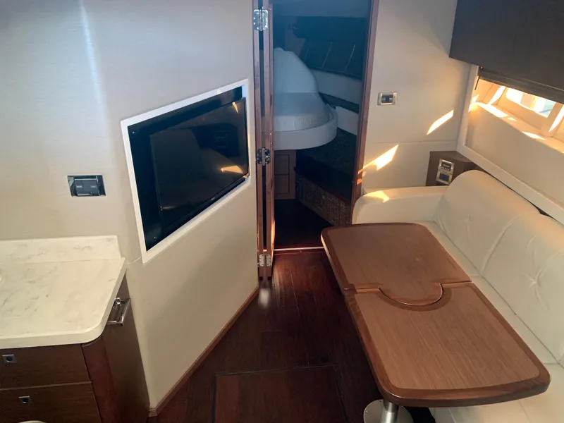 Slide: The Image of Interior of 2014 Sea Ray 410 Sundancer yacht with cozy seating and modern amenities. - 27