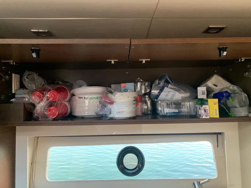 Slide: The Image of Cabinet storage in 2014 Sea Ray 410 Sundancer yacht with cups and plates. - 33