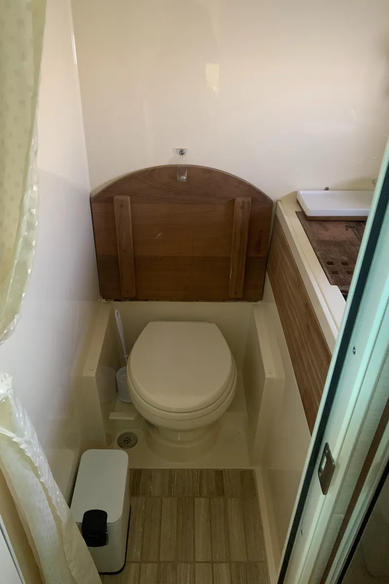 Slide: The Image of 2014 Sea Ray 410 Sundancer bathroom with modern fixtures and wood accents. - 38