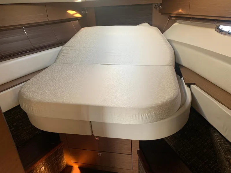 Slide: The Image of Interior cabin of 2014 Sea Ray 410 Sundancer with a comfortable bed. - 47