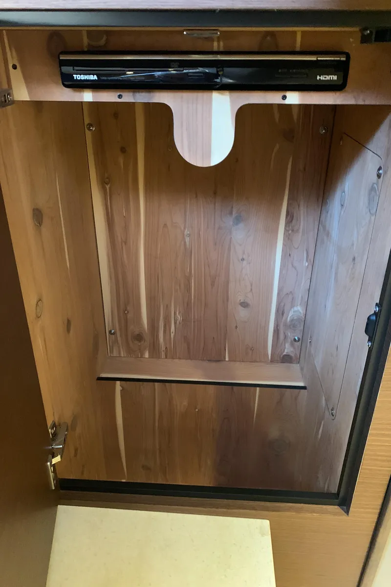 Slide: The Image of Wooden cabinet interior with Toshiba DVD player, Sea Ray 410 Sundancer 2014 model. - 49