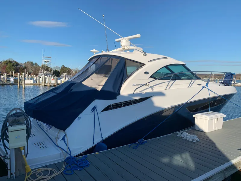 Slide: The Image of 2014 Sea Ray 410 Sundancer yacht docked at marina under clear blue sky. - 5