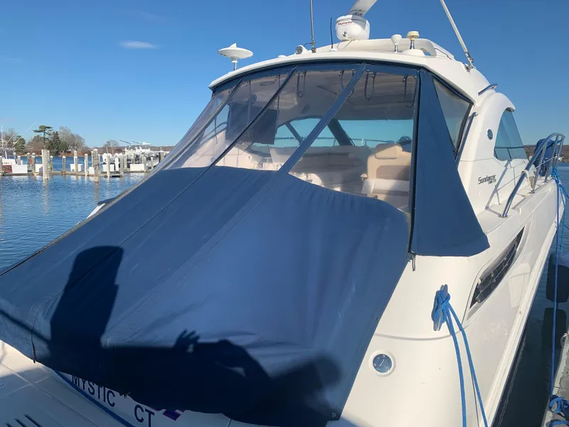 Slide: The Image of 2014 Sea Ray 410 Sundancer yacht docked with blue cover, sunny day. - 7