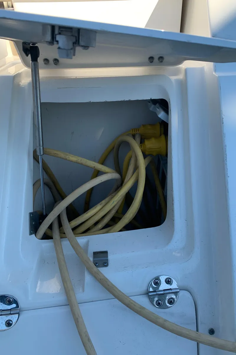 Slide: The Image of 2014 Sea Ray 410 Sundancer power compartment with yellow cables. - 9