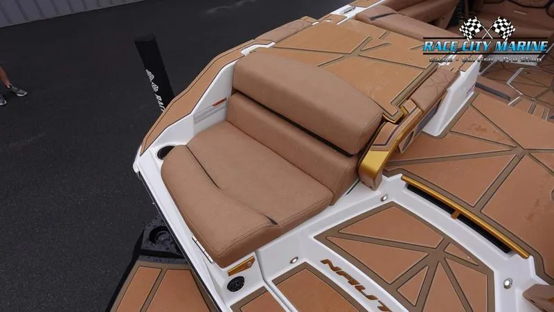 Slide: The Image of 2025 Nautique Super Air Nautique G23 Paragon boat interior with tan seating and deck. - 15