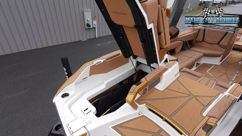 Slide: The Image of 2025 Nautique Super Air Nautique G23 Paragon interior with tan seating and storage. - 21