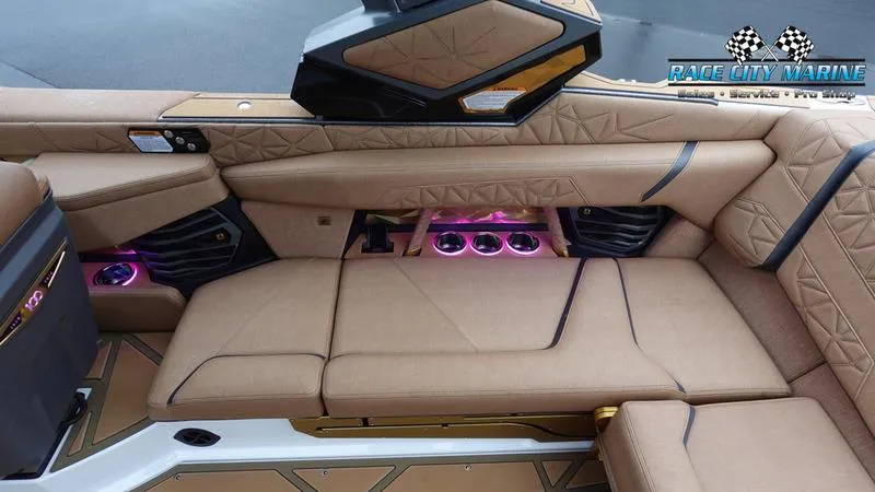 Slide: The Image of 2025 Nautique Super Air Nautique G23 Paragon interior with luxurious tan seating and ambient lighting. - 31