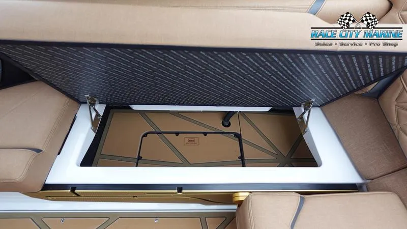 Slide: The Image of 2025 Nautique Super Air Nautique G23 Paragon storage compartment with open lid. - 33