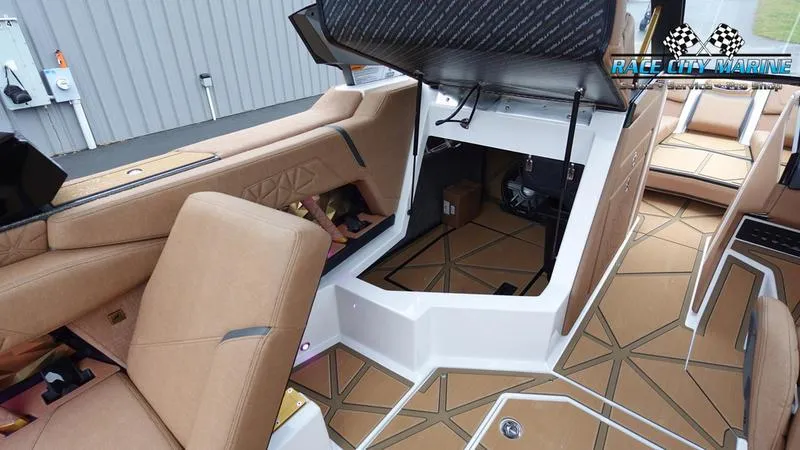 Slide: The Image of 2025 Nautique Super Air Nautique G23 Paragon interior with tan seating and storage. - 38
